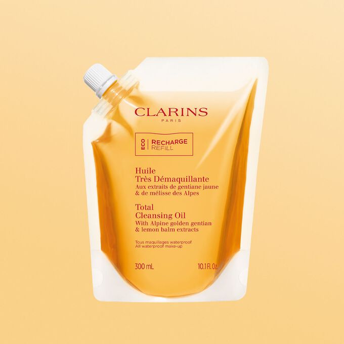 The Clarins Total Cleansing Oil orange eco-refill, offering a sustainable and effective solution for makeup removal and skincare