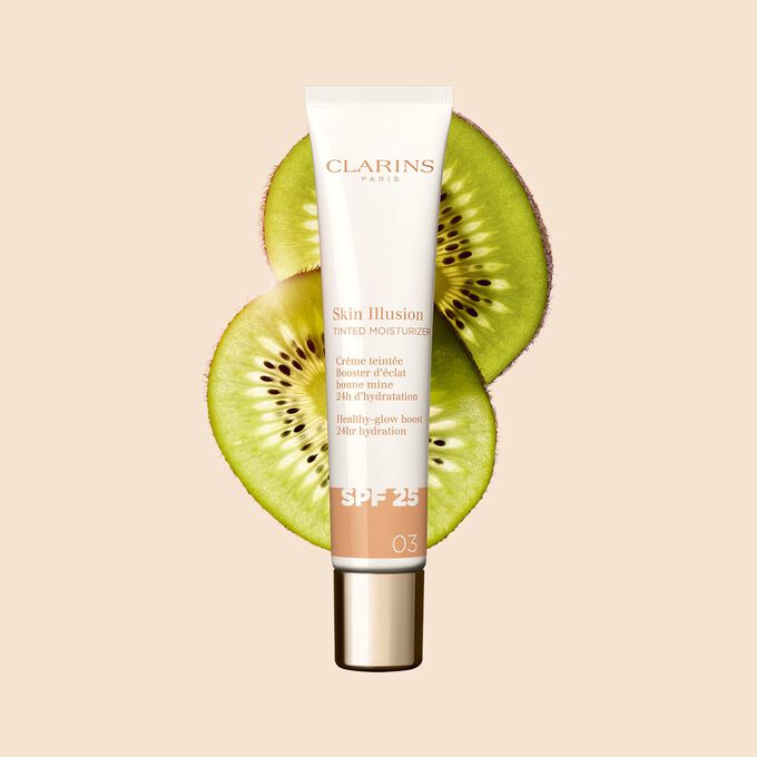 Packshot of the 40ml tube of Skin perfector Skin Illusion Tinted Moisturizer shade 03 placed next to kiwi slides