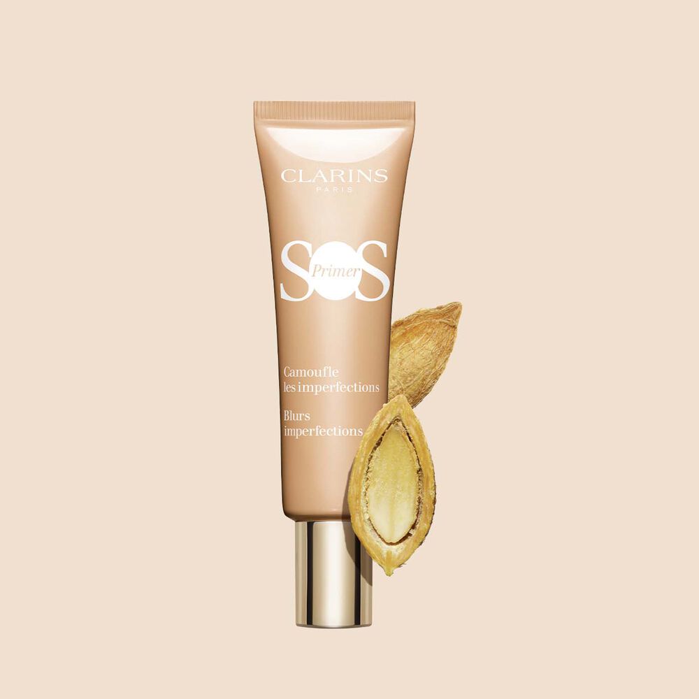 Packshot of a tube of SOS Primer Peach by Clarins, featuring a desert date, to blur imperfections and even skin tone​
