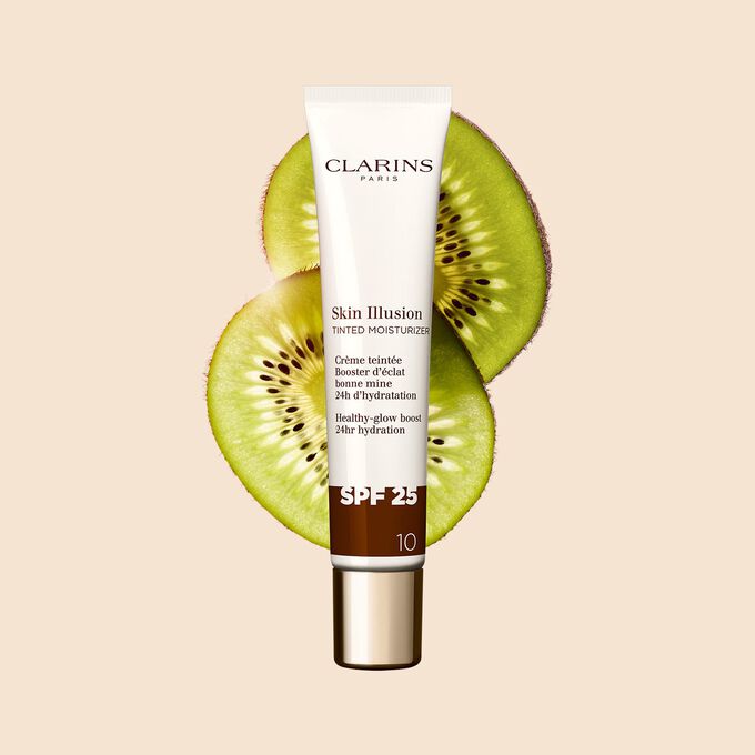 Packshot of the 40ml tube of Skin perfector Skin Illusion Tinted Moisturizer shade 10 placed next to kiwi slides