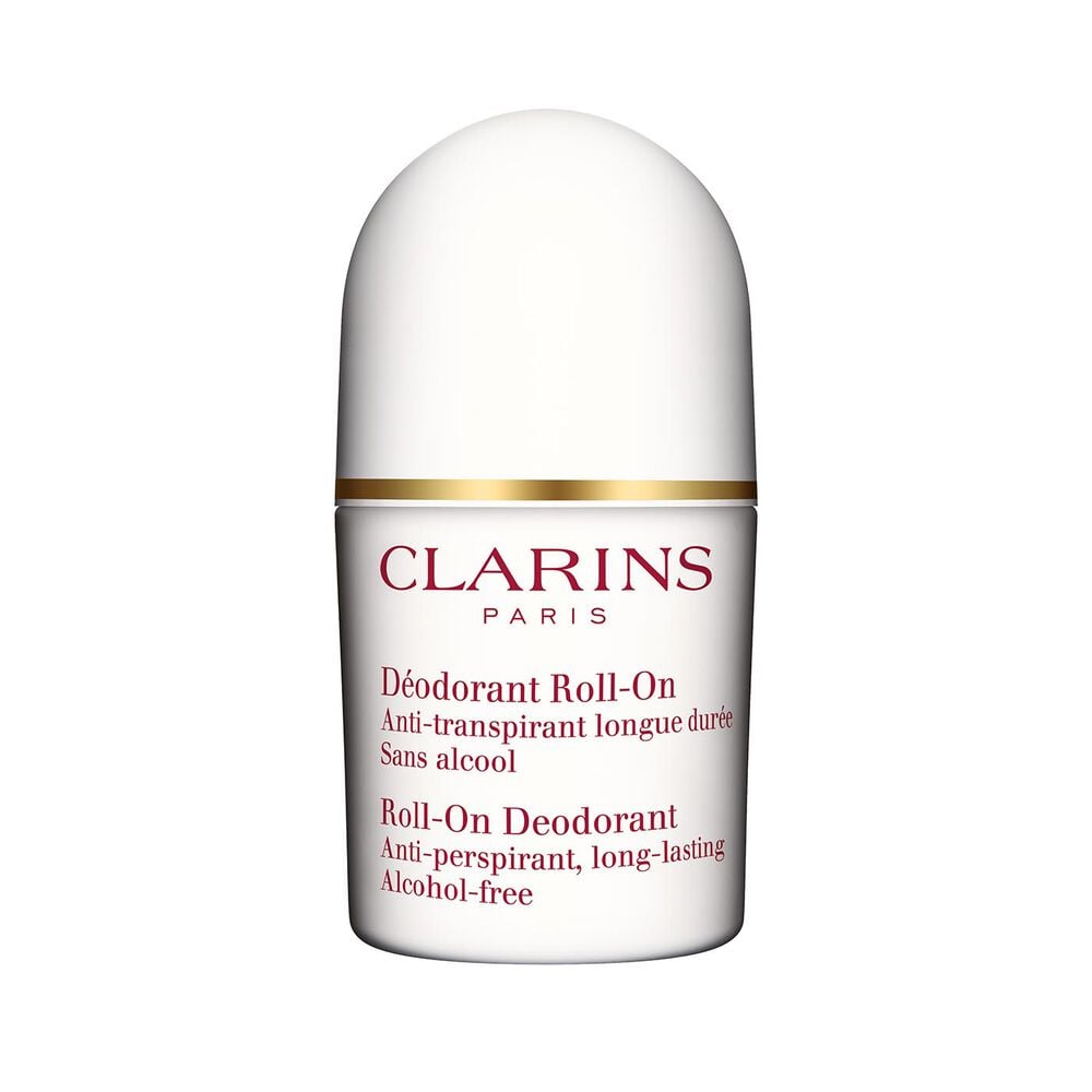 Packshot of a Deo roll-on for sensitive skin close to some blades of rosemary on a white background.