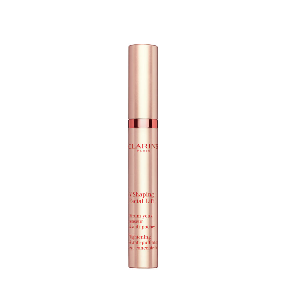Packshot of a tube of the V Shaping Facial Lift Eye by Clarins close to irish moss on a light pink background.