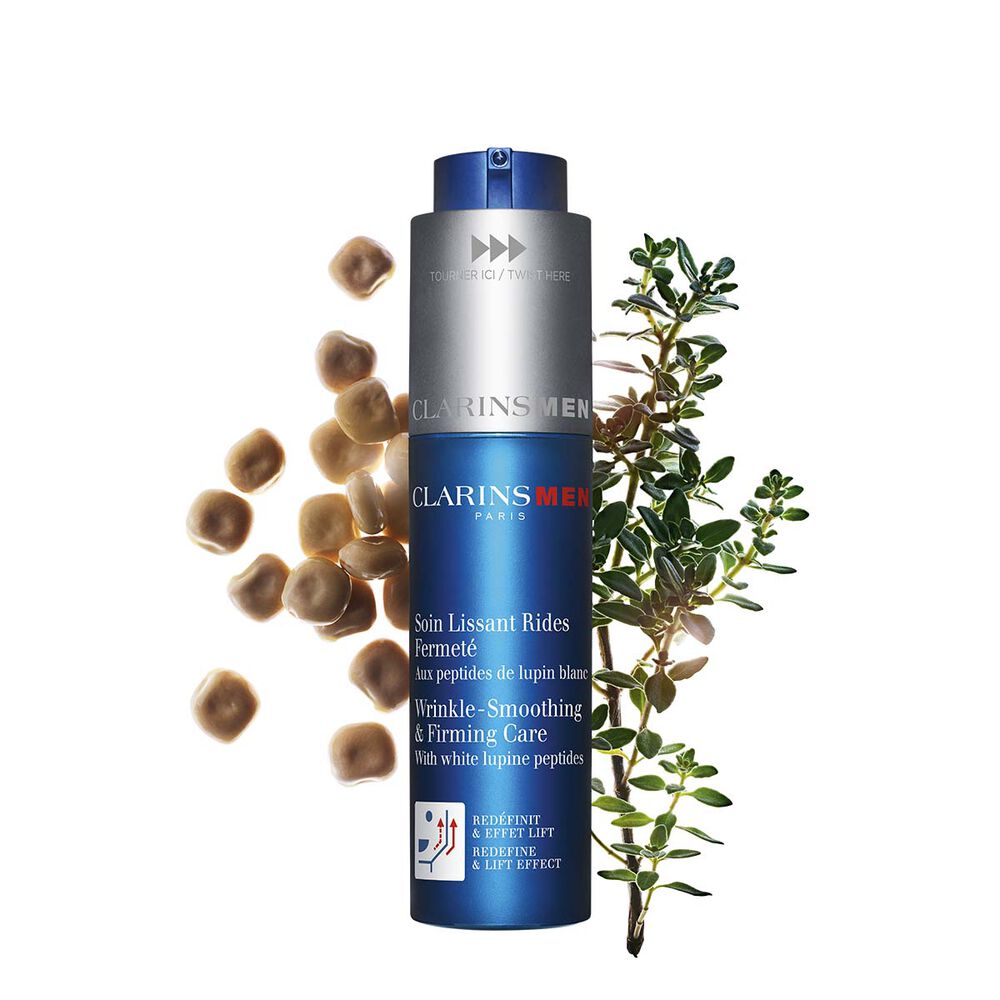 Packshot of the men's anti-ageing concentrate by Clarins next to white lupines on a light blue background to emphasize its key ingredient.