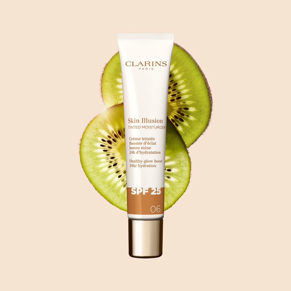Packshot of the 40ml tube of Skin perfector Skin Illusion Tinted Moisturizer shade 06 placed next to kiwi slides