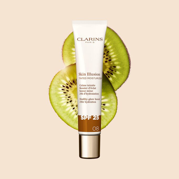 Packshot of the 40ml tube of Skin perfector Skin Illusion Tinted Moisturizer shade 08 placed next to kiwi slides