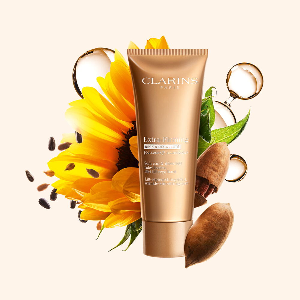 Packshot of Clarins Firming Neck & D&eacute;collet&eacute; Cream surrounded by collagen, pecan nuts, and sunflower to highlight its key ingredients.