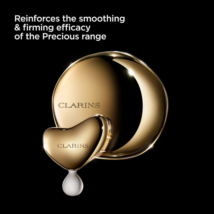 Photoshoot of Clarins Massage Tool on dark background, with text emphasising its utility for the Precious range.