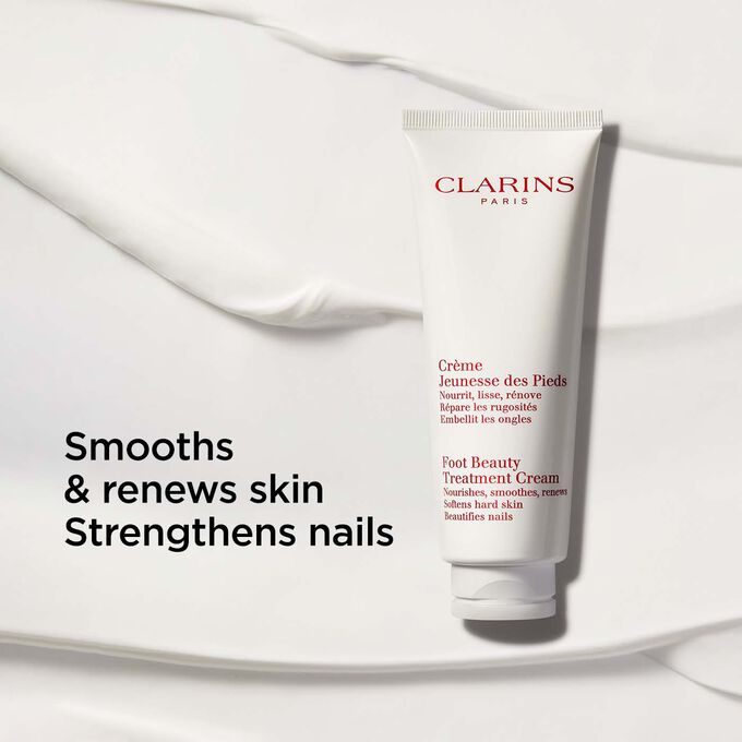 Packshot of Clarins Foot Beauty Treatment Cream on a creamy-textured background with text emphasising its nourishing benits