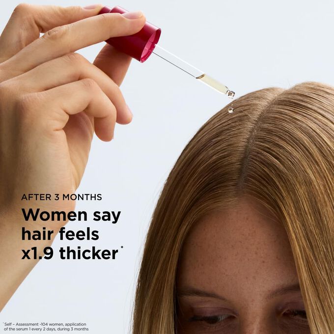Applying hair loss serum directly to the scalp to improve hair longevity and stimulate density for a thicker appearance