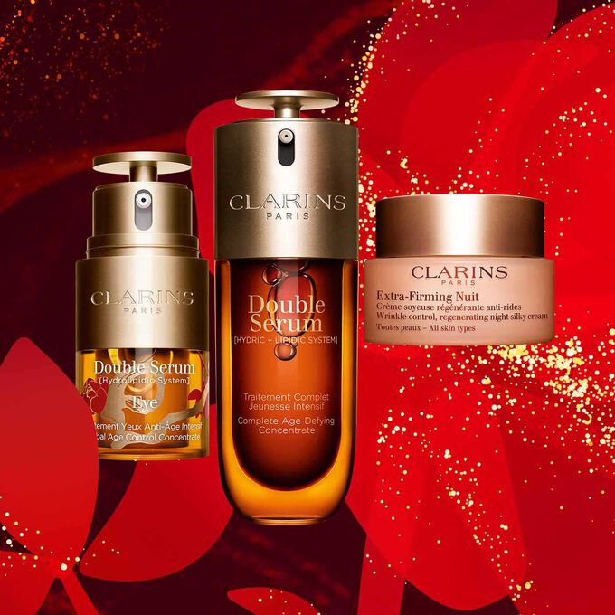 Clarins daily skincare products, featuring the Eye Double Serum Limited Edition, Double Serum, and Extra-Firming Night Care.