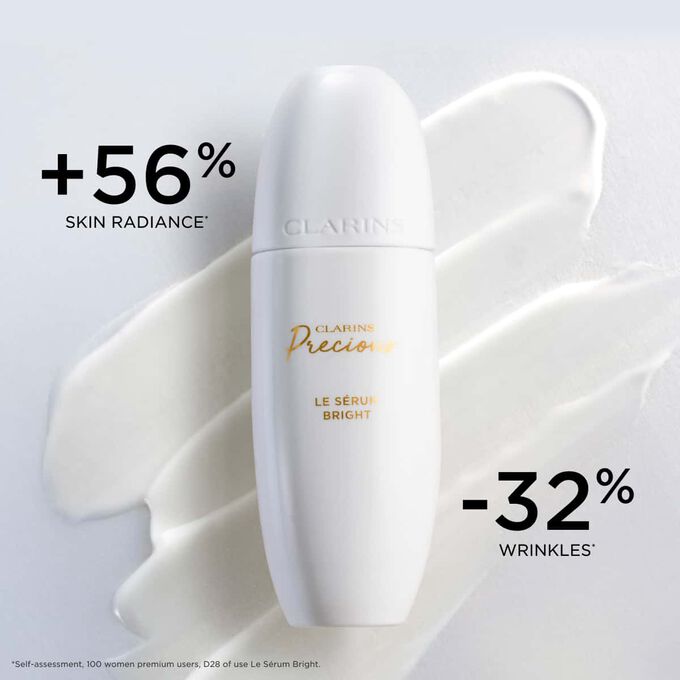 Packshot of Clarins Precious Brightening Serum on a textured background, highlighting its effect on skin radiance and wrinkle reduction.