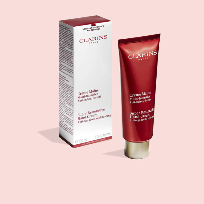 Tube of Clarins Super Restorative Hand Cream next to its packaging to illustrate the recyclable origin of the packaging