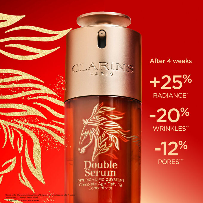 Close-up of the limited edition Double Serum and its special packaging on a red background, highlighting its firming and radiance effects.