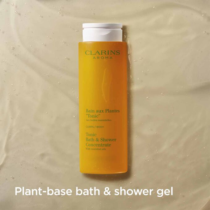 Packshot of Clarins Tonic Bath and Shower Concentrate with text emphasising it is a fragrant plant-based shower gel.