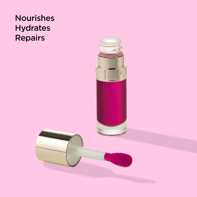 Packshot of Clarins Lip Comfort Oil 02 Rasberry with text emphasising on its nourishing, hydrating and repairing benefits.