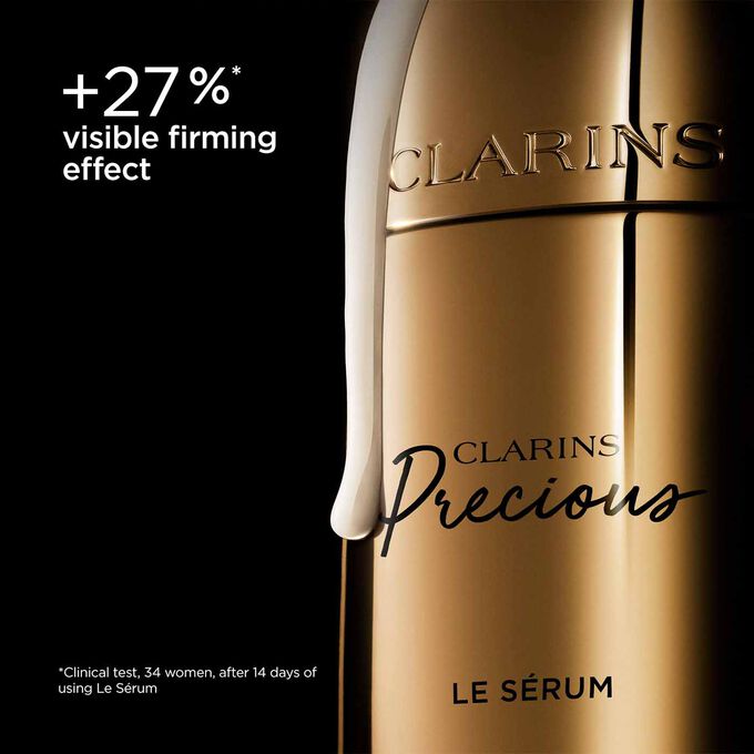 Packshot of Clarins Precious Serum on dark background, with text emphasising its power to lift and improve skin contour.