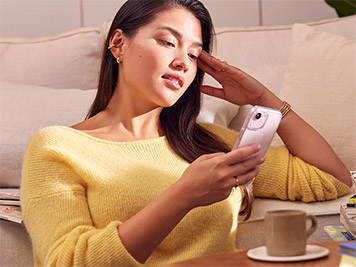 Focus on a woman comfy at home using her device